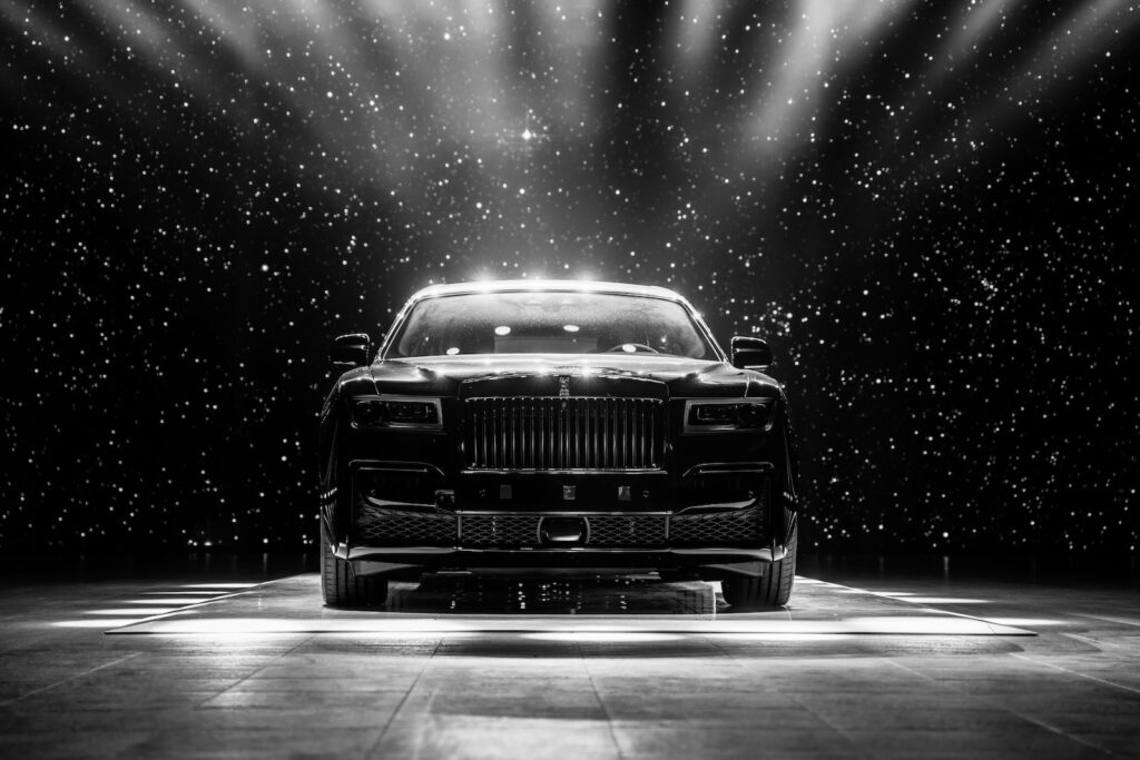 a black and white photo of a car on a stage